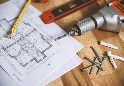 Building plans with tools beside